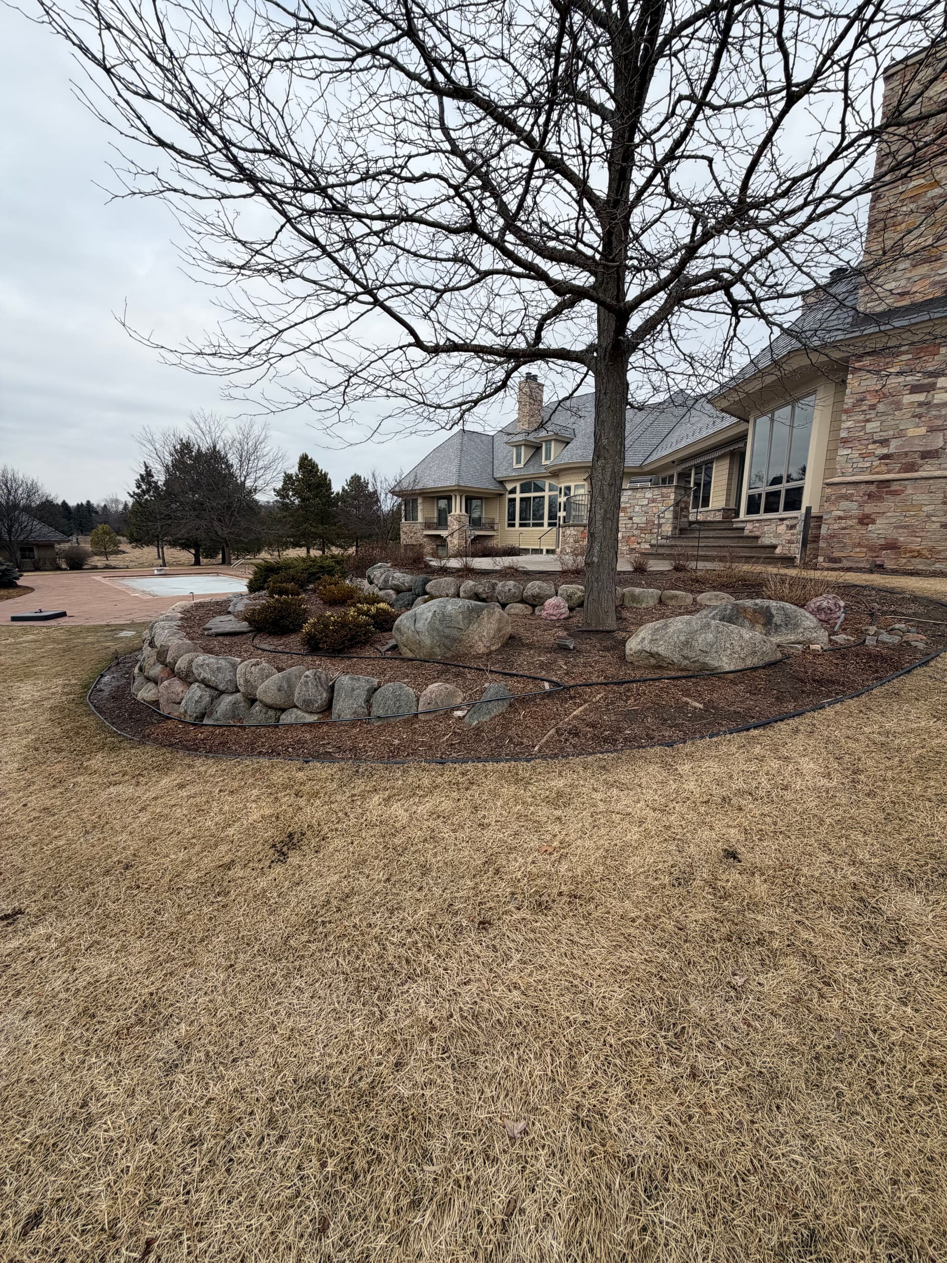 Gallery photos for River Rock Bed Refresh with Clean Edging and Drip Irrigation: Image #1